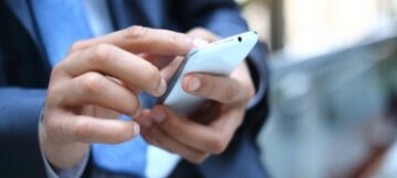 Nahaufnahme von einer Hand, die ein Smartphone bedient